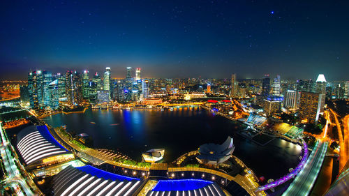 High angle view of city lit up at night