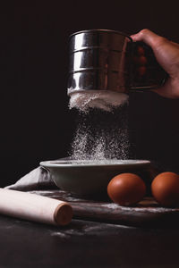 Close-up of person preparing food in bowl
