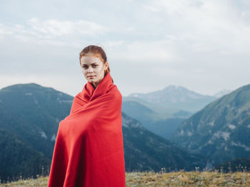 Woman standing on mountain against sky