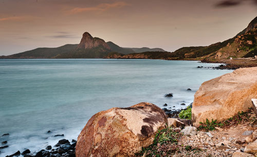 Scenic view of sea and mountains against sky