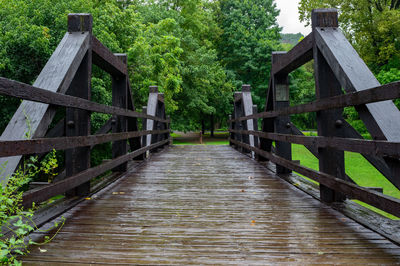 A wooden bridge in the forest on a wet rainy day.