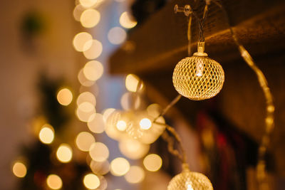 Close-up of illuminated christmas lights hanging on wood