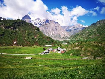 Scenic view of field and mountains against sky