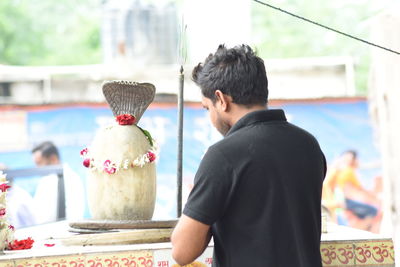 Rear view of man standing at home