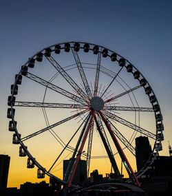 Low angle view of ferris wheel against sky