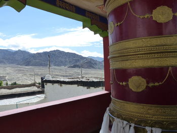 Scenic view of mountains against sky seen through window