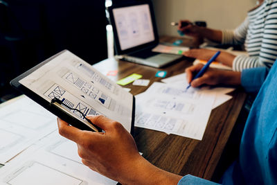 High angle view of man using smart phone on table