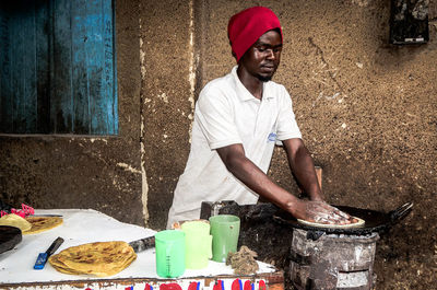 Side view of man working at table