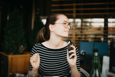Portrait of young woman standing outdoors
