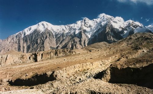 Scenic view of snowcapped mountains against blue sky