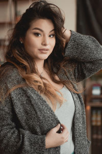 Portrait of young woman standing in cafe