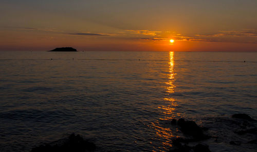 Scenic view of sea against sky during sunset