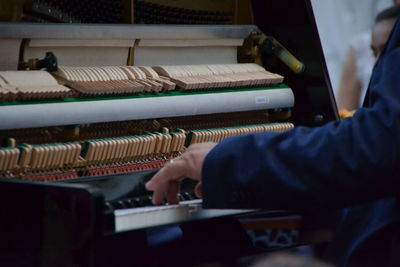 Cropped hand playing piano