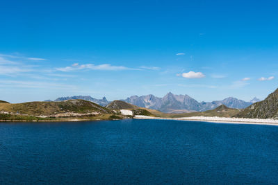 Scenic view of mountains against blue sky