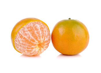 Close-up of orange fruit against white background