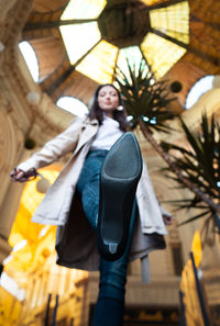 Full length of woman with arms raised