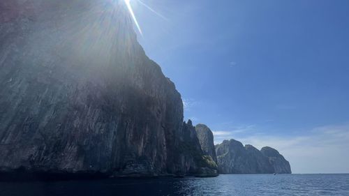 Rock formation in sea against sky