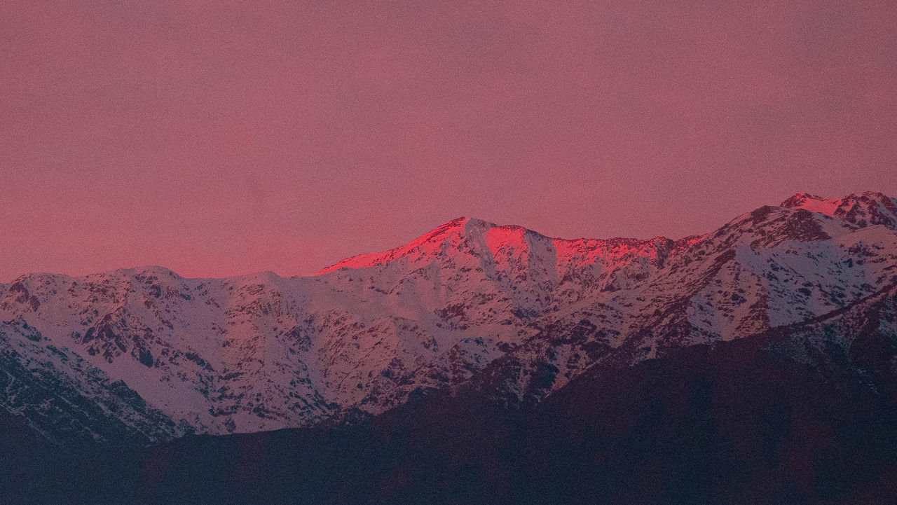 SCENIC VIEW OF SNOWCAPPED MOUNTAINS AGAINST SKY AT SUNSET