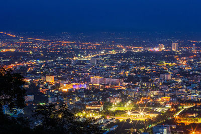 High angle view of illuminated buildings in city at night