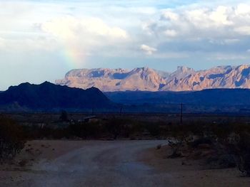 Scenic view of mountains against cloudy sky