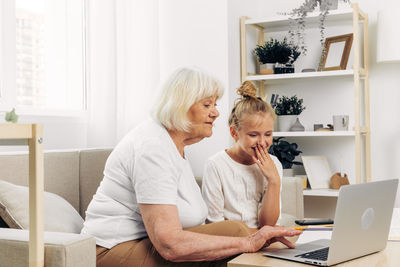 Young woman using laptop at home