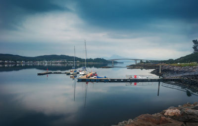 Sailboats in lake against sky