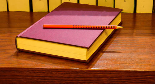 High angle view of pink book on table