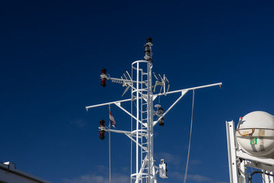 Low angle view of lighthouse against clear blue sky