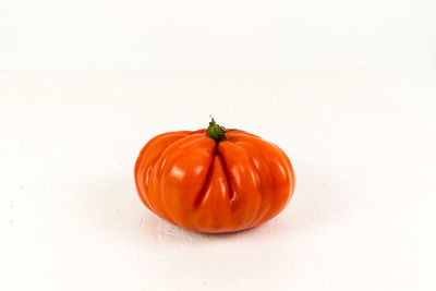 Close-up of orange fruit against white background