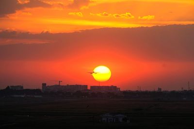 Scenic view of silhouette landscape against romantic sky at sunset