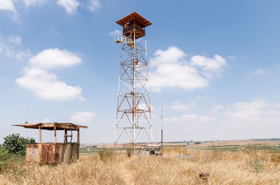 Windmill on field against sky