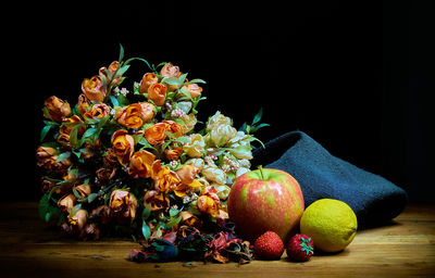 Close-up of fruits on table against black background