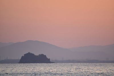 Scenic view of sea against orange sky