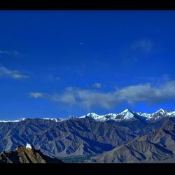 Scenic view of mountains against cloudy sky