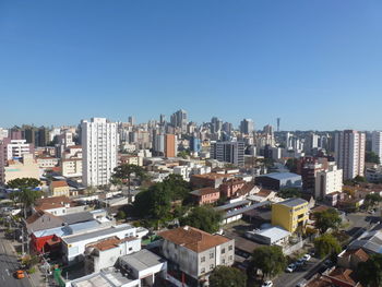 Cityscape against clear blue sky