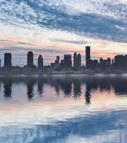 Scenic view of city against sky during sunset