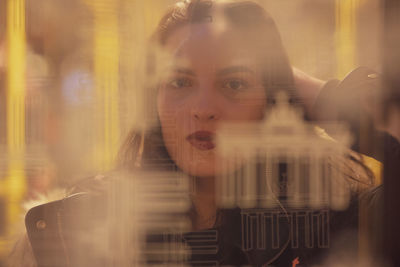 Reflection of woman on train window at subway station