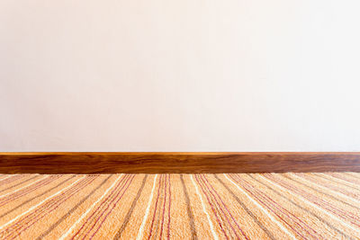 Wooden floor against wall at home