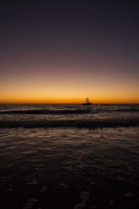 Scenic view of sea against clear sky during sunset