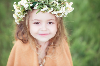 Portrait of girl wearing wreath at park