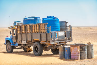Water wagons and water barrels in the middle of the desert of sudan, africa