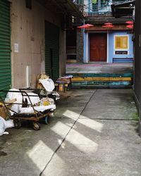 Footpath by street against buildings in city