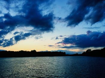 Scenic view of lake against sky at sunset
