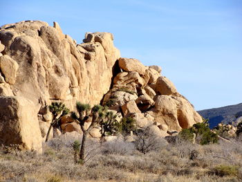 Rock formations on landscape against sky