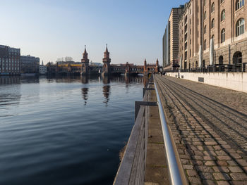 View of oberbaumbrücke at waterfront of spree river in berlin, germany