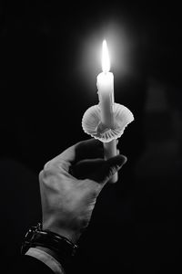 Close-up of lit candle in dark room