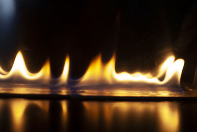 Close-up of fire burning at night