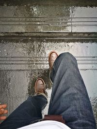Low section of man standing on staircase