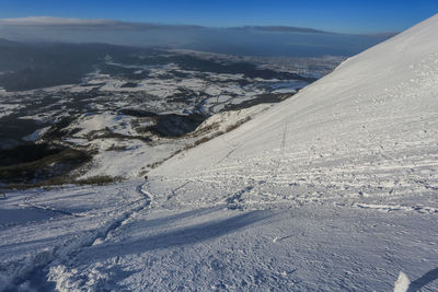 Scenic view of snow covered mountains against sky