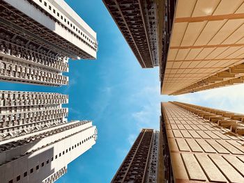 Low angle view of modern skyscrapers against sky